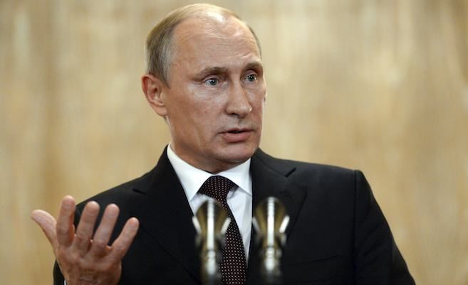 Russia's President Vladimir Putin gestures as he speaks during a news conference after the Asia-Europe Meeting in Milan, Oct. 17, 2014.