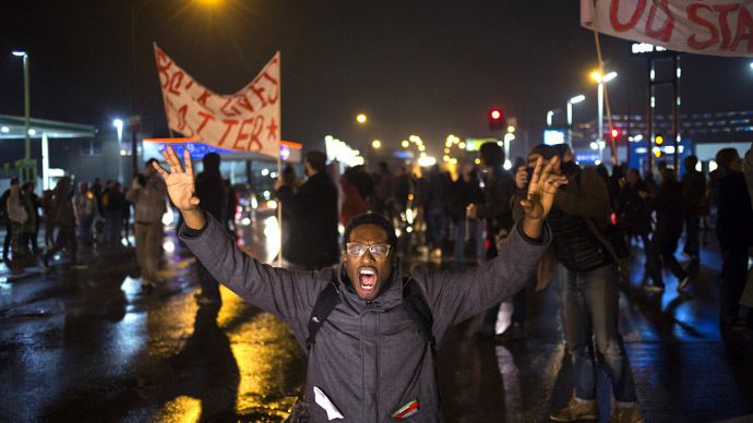 A protester, demanding the criminal indictment of a white police officer who shot dead an unarmed black teenager in August, shouts slogans while stopping traffic while marching through a suburb in St. Louis, Missouri November 23, 2014. (Reuters)