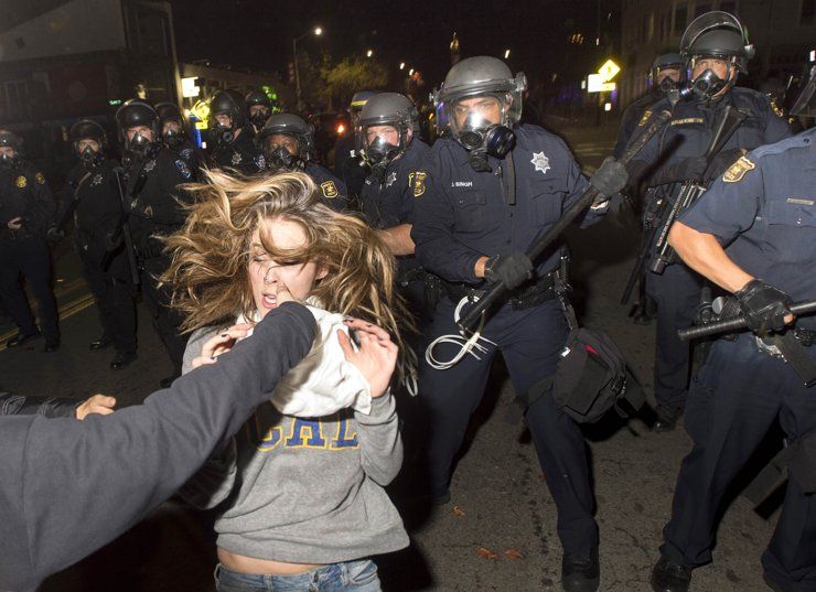 A protester flees as police officers try to disperse a crowd comprised largely of student demonstrators during a protest against police violence in the U.S., in Berkeley, California early December 7, 2014. (Reuters)