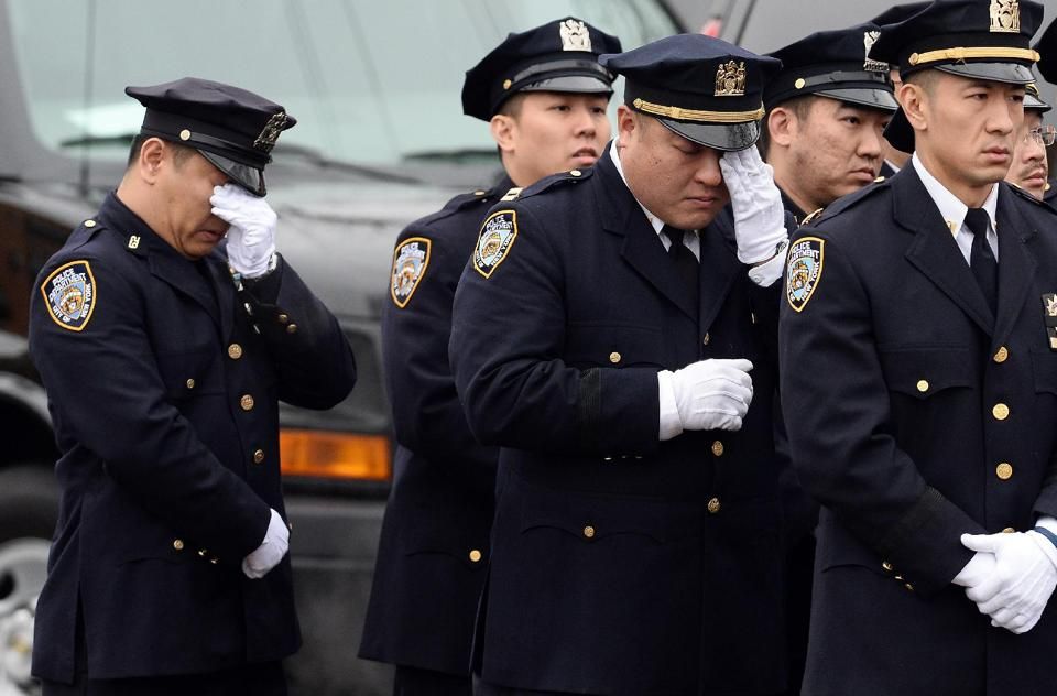 NYPD officers cry during the funeral of their fellow officer Wenjian Liu in Brooklyn on January 4, 2015 (AFP Photo