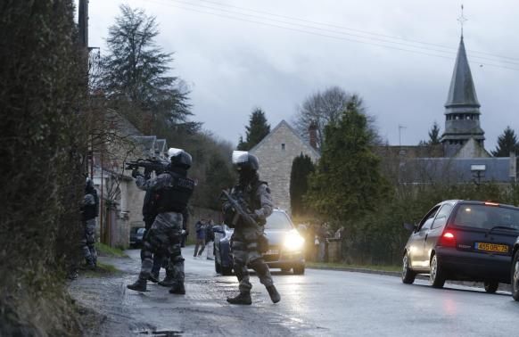 Members of the French GIPN intervention police forces secure a neighbourhood in Corcy, northeast of Paris January 8, 2015. 