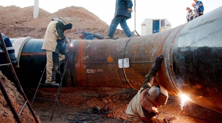 Welders construct a gas pipeline in Kazakhstan.