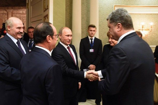 Russian President Vladimir Putin shakes hands with Ukrainian President Petro Poroshenko on Feb. 11 in Minsk. The leaders of Ukraine, Russia, France and Germany have agreed on a ceasefire deal. 