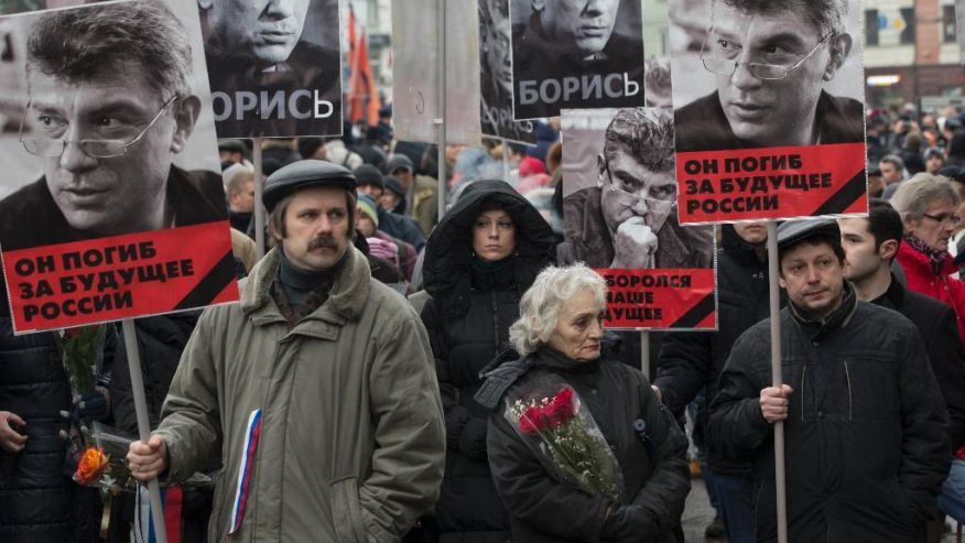 March 1, 2015: People carry portraits of opposition leader Boris Nemtsov, who was gunned down on Friday, Feb. 27, 2015 near the Kremlin, with words reading 'he died for the future of Russia!' in Moscow, Russia. (AP)