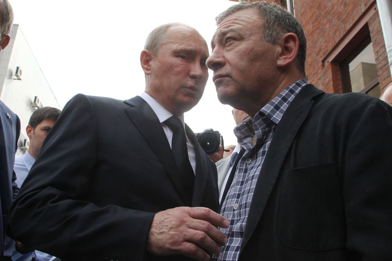 Russian President Vladimir Putin, left, and billionaire Arkady Rotenberg attend the funeral of a former judo trainer in St. Petersburg in 2013. PHOTO: GETTY IMAGES