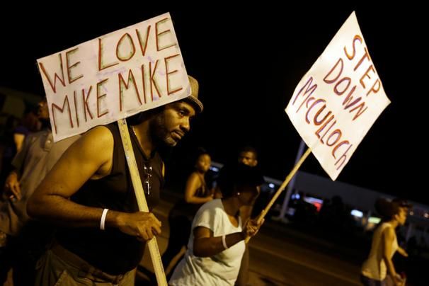 Protesters again gathered Thursday evening, walking in laps near the spot where Michael Brown was shot. Some were in organized groups, such as clergy members. More signs reflected calls by protesters to remove the prosecutor, Robert McCulloch, from the case. Photo: Associated Press