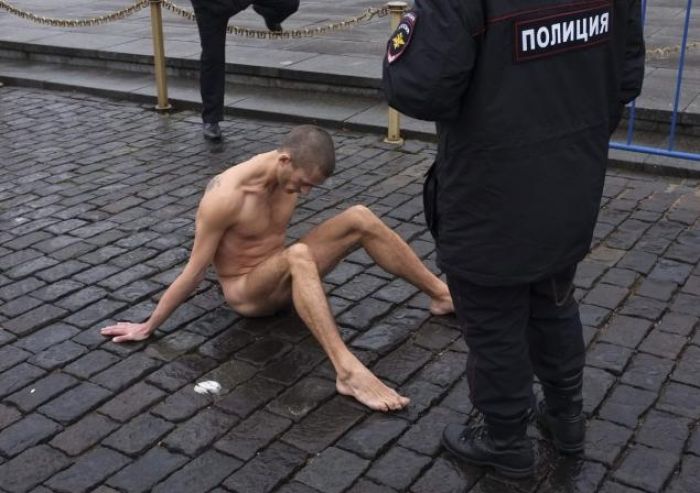 Naked artist nails scrotum to ground in protest at Moscow's Red Square