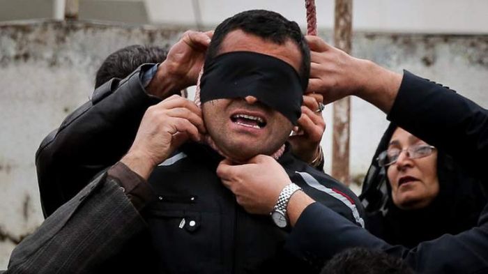 Iran murder victim's mother forgives killer, stops hanging